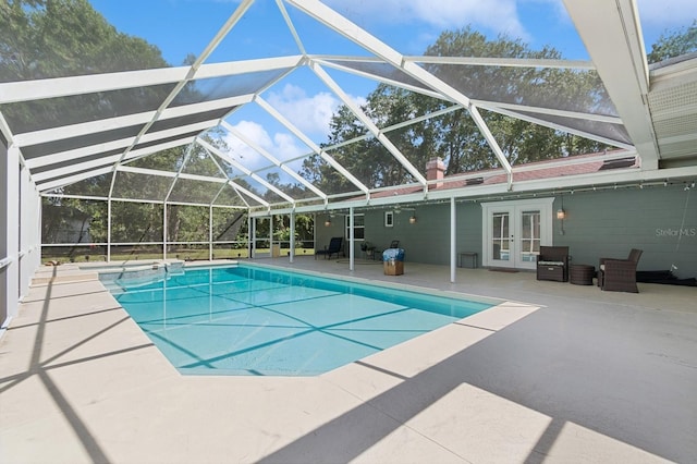 2626 NW 36th Pl, Gainesville, FL 32605 - view of swimming pool featuring french doors, a patio area, a pool with connected hot tub, and a lanai