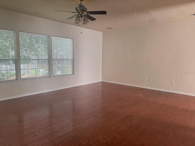 9405 SW 31st Ln, Gainesville, FL 32608 - empty room featuring dark wood finished floors, a ceiling fan, and recessed lighting