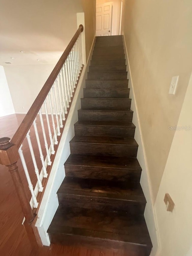 9405 SW 31st Ln, Gainesville, FL 32608 - staircase featuring wood finished floors