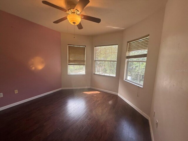 9405 SW 31st Ln, Gainesville, FL 32608 - unfurnished room featuring healthy amount of natural light, dark wood-style floors, and a ceiling fan
