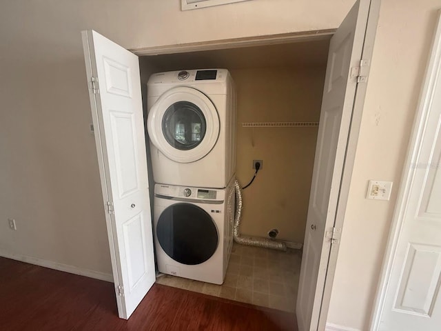9405 SW 31st Ln, Gainesville, FL 32608 - washroom with stacked washer / dryer and wood finished floors