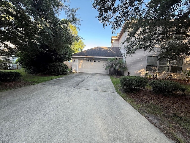 9405 SW 31st Ln, Gainesville, FL 32608 - view of side of home with concrete driveway and an attached garage