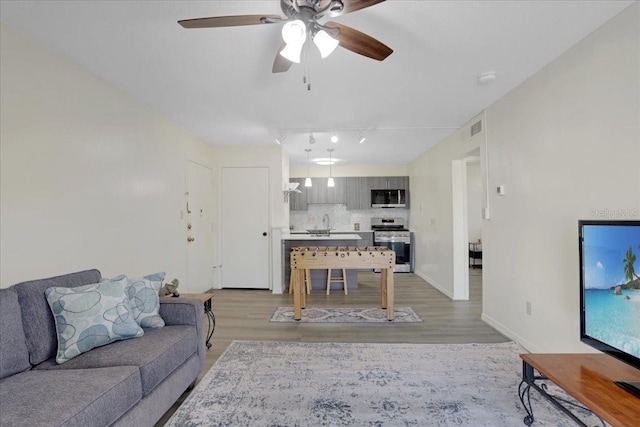 1700 SW 16th Ct Unit E30, Gainesville, FL 32608 - living area featuring a ceiling fan, light wood-style floors, and track lighting