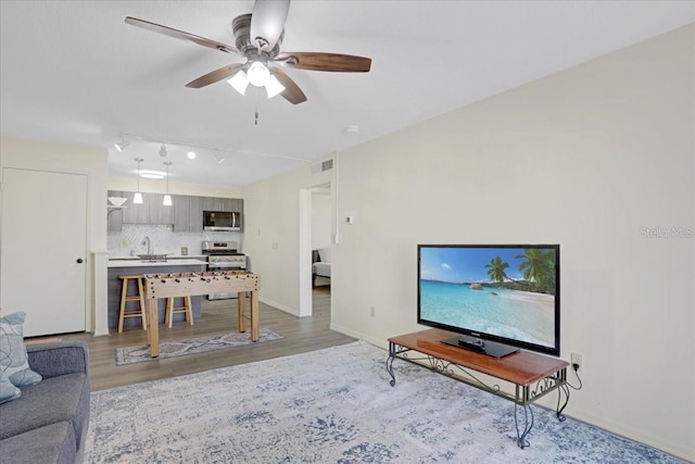 1700 SW 16th Ct Unit E30, Gainesville, FL 32608 - living room featuring a ceiling fan, light wood-type flooring, and track lighting