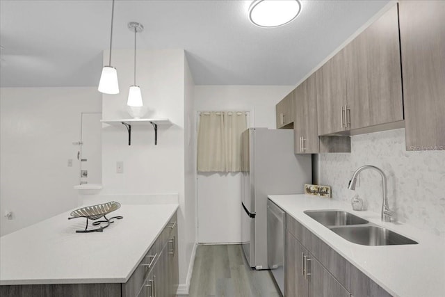 1700 SW 16th Ct Unit E30, Gainesville, FL 32608 - kitchen with light wood finished floors, dishwasher, light countertops, and a peninsula