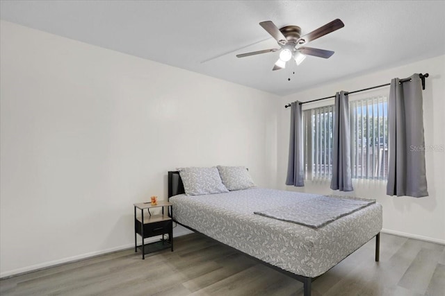 1700 SW 16th Ct Unit E30, Gainesville, FL 32608 - bedroom with wood finished floors and ceiling fan