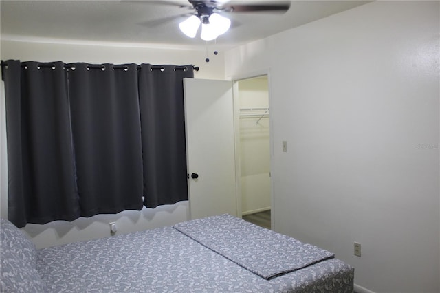 1700 SW 16th Ct Unit E30, Gainesville, FL 32608 - bedroom with ceiling fan and a walk in closet