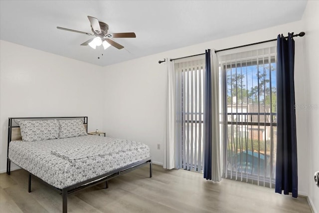 1700 SW 16th Ct Unit E30, Gainesville, FL 32608 - bedroom with wood finished floors and a ceiling fan