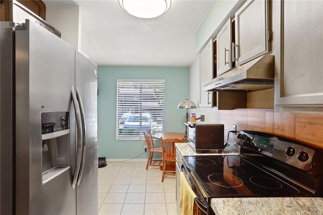 3958 NW 27th Ln, Gainesville, FL 32606 - kitchen featuring black range with electric cooktop, stainless steel fridge with ice dispenser, under cabinet range hood, light tile patterned flooring, and light countertops