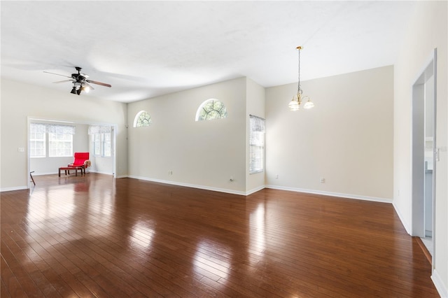 6033 NW 36th Dr, Gainesville, FL 32653 - unfurnished living room featuring healthy amount of natural light, a chandelier, a ceiling fan, and wood-type flooring