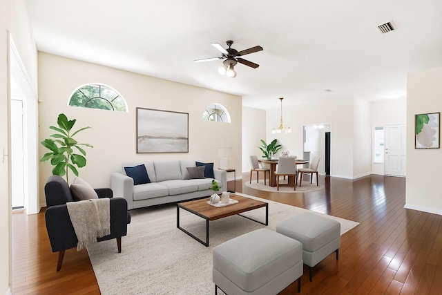 6033 NW 36th Dr, Gainesville, FL 32653 - living room with dark wood-style flooring, a ceiling fan, and a chandelier