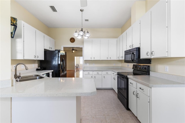 6033 NW 36th Dr, Gainesville, FL 32653 - kitchen featuring black appliances, a ceiling fan, a chandelier, a peninsula, and white cabinetry