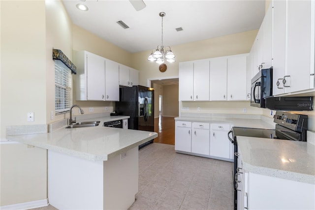 6033 NW 36th Dr, Gainesville, FL 32653 - kitchen featuring black appliances, a peninsula, hanging light fixtures, light stone counters, and recessed lighting