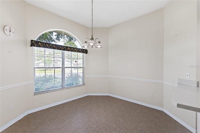 6033 NW 36th Dr, Gainesville, FL 32653 - empty room featuring healthy amount of natural light and a chandelier