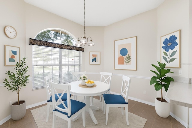 6033 NW 36th Dr, Gainesville, FL 32653 - tiled dining room with a chandelier and a towering ceiling