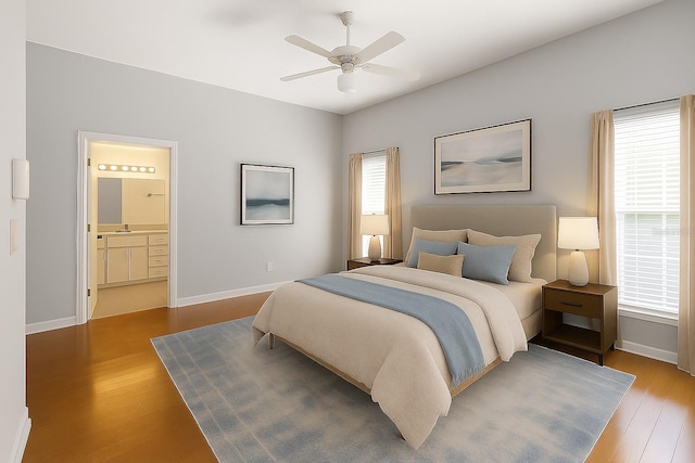6033 NW 36th Dr, Gainesville, FL 32653 - bedroom featuring wood finished floors, connected bathroom, and a ceiling fan