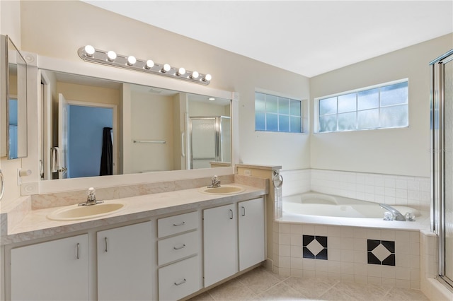 6033 NW 36th Dr, Gainesville, FL 32653 - full bathroom featuring double vanity, a bath, a shower stall, and tile patterned flooring