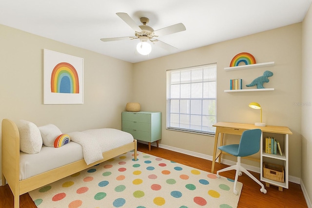 6033 NW 36th Dr, Gainesville, FL 32653 - bedroom with wood finished floors and ceiling fan