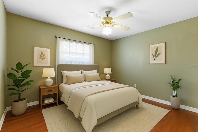 6033 NW 36th Dr, Gainesville, FL 32653 - bedroom featuring wood finished floors and ceiling fan