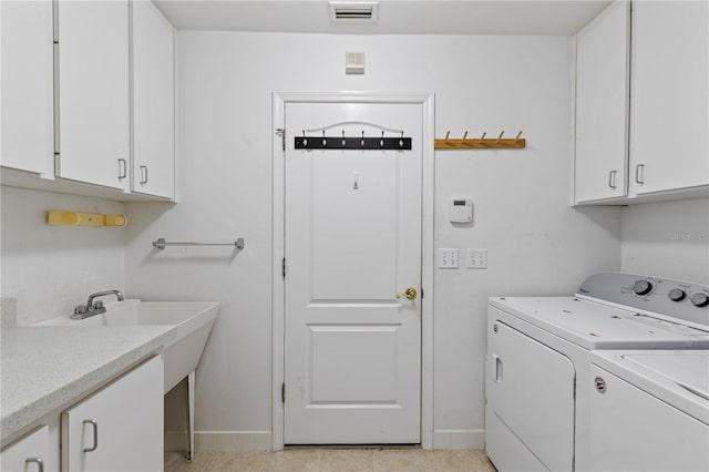 6033 NW 36th Dr, Gainesville, FL 32653 - laundry room with cabinet space and washer and dryer
