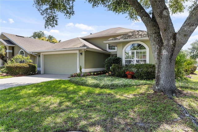 6033 NW 36th Dr, Gainesville, FL 32653 - view of front of home featuring stucco siding, a garage, driveway, and a front yard