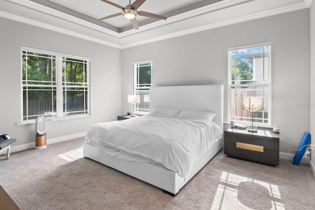 9474 SW 65th Pl, Gainesville, FL 32608 - bedroom with ornamental molding, multiple windows, carpet flooring, a raised ceiling, and a ceiling fan