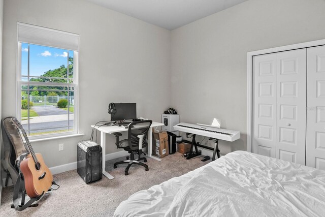 9474 SW 65th Pl, Gainesville, FL 32608 - carpeted bedroom featuring multiple windows, a closet, and a desk