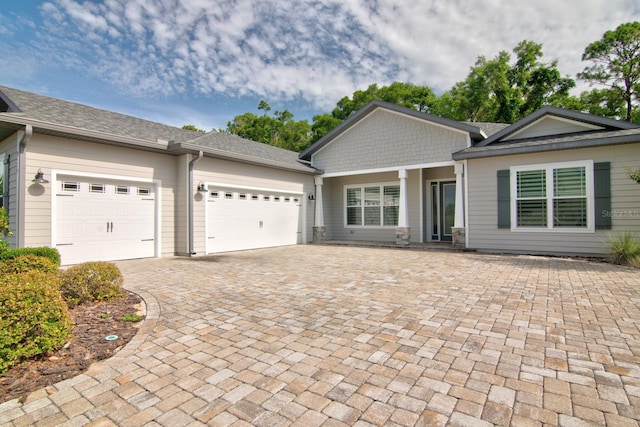 9474 SW 65th Pl, Gainesville, FL 32608 - view of front of house with a garage, decorative driveway, and a shingled roof