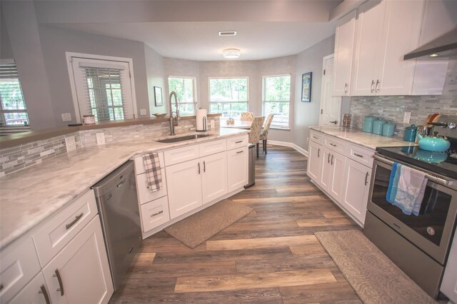 2361 Sandy Run Dr N, Middleburg, FL 32068 - kitchen featuring stainless steel appliances, ventilation hood, white cabinetry, and backsplash