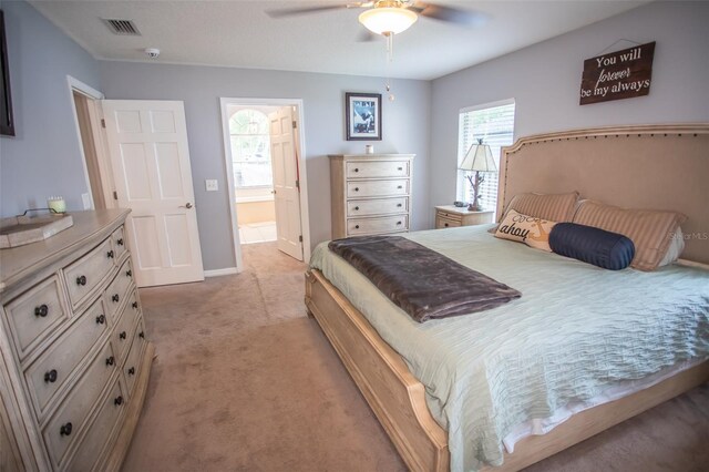 2361 Sandy Run Dr N, Middleburg, FL 32068 - bedroom with light carpet, a ceiling fan, and ensuite bath