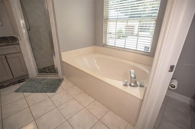 2361 Sandy Run Dr N, Middleburg, FL 32068 - bathroom with a garden tub, a shower stall, tile patterned floors, and vanity