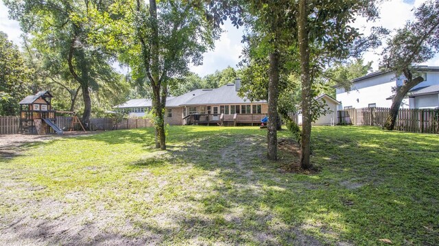 2361 Sandy Run Dr N, Middleburg, FL 32068 - fenced backyard with a playground and a deck