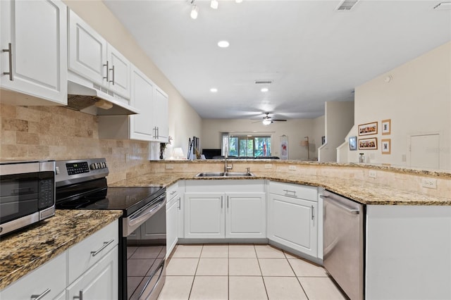 13200 W Newberry Rd Unit T110, Newberry, FL 32669 - kitchen featuring stainless steel appliances, under cabinet range hood, a ceiling fan, light tile patterned flooring, and backsplash