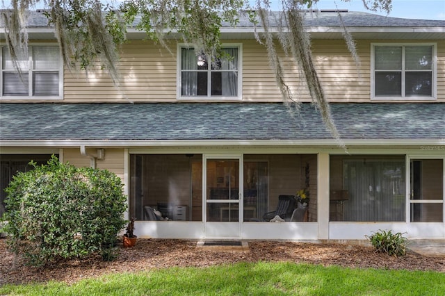 13200 W Newberry Rd Unit T110, Newberry, FL 32669 - back of property featuring a shingled roof and a sunroom
