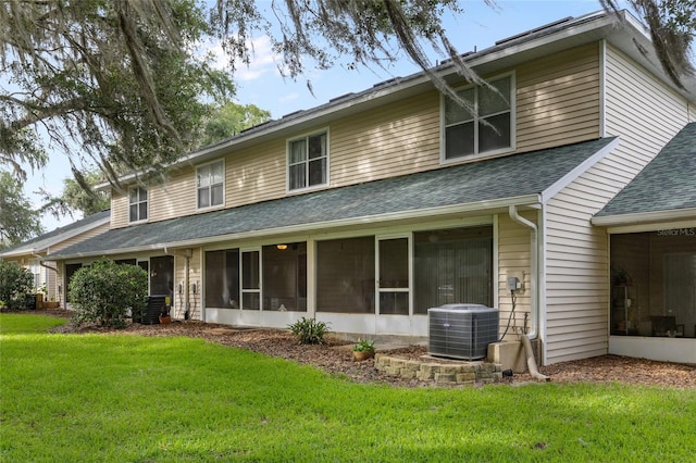 13200 W Newberry Rd Unit T110, Newberry, FL 32669 - rear view of property featuring roof with shingles, a sunroom, and a lawn