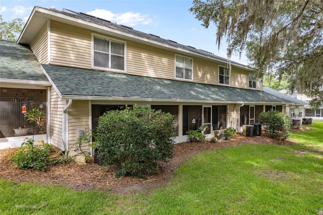 13200 W Newberry Rd Unit T110, Newberry, FL 32669 - view of front of home with roof with shingles, a front lawn, and a sunroom