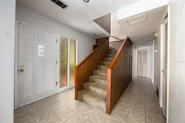 2147 NW 7th Pl, Gainesville, FL 32603 - foyer with light tile patterned floors and stairs