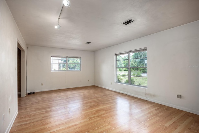 2147 NW 7th Pl, Gainesville, FL 32603 - unfurnished room with light wood-type flooring and rail lighting