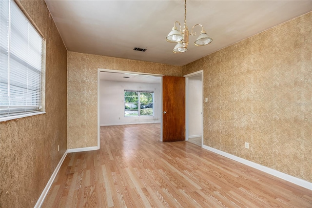 2147 NW 7th Pl, Gainesville, FL 32603 - spare room with light wood finished floors and a chandelier