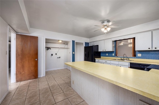 2147 NW 7th Pl, Gainesville, FL 32603 - kitchen with black appliances, light countertops, ceiling fan, white cabinetry, and light tile patterned floors