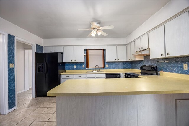 2147 NW 7th Pl, Gainesville, FL 32603 - kitchen with black appliances, under cabinet range hood, light countertops, and ceiling fan
