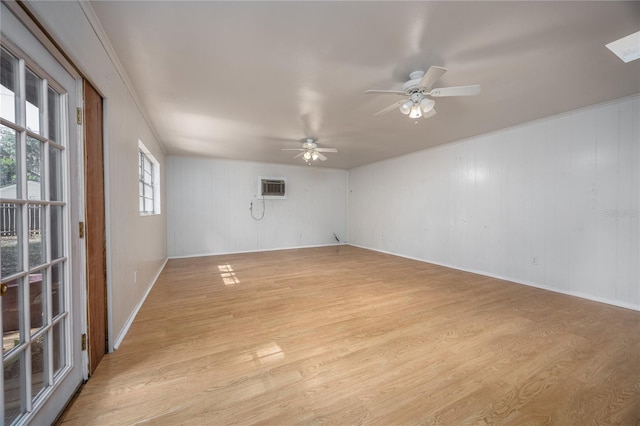 2147 NW 7th Pl, Gainesville, FL 32603 - spare room with light wood-style flooring, a wall mounted AC, plenty of natural light, and ceiling fan