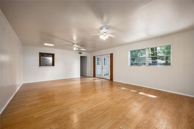 2147 NW 7th Pl, Gainesville, FL 32603 - empty room with wood finished floors, french doors, and a ceiling fan