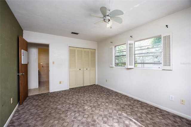 2147 NW 7th Pl, Gainesville, FL 32603 - unfurnished bedroom with carpet flooring, a closet, and a ceiling fan