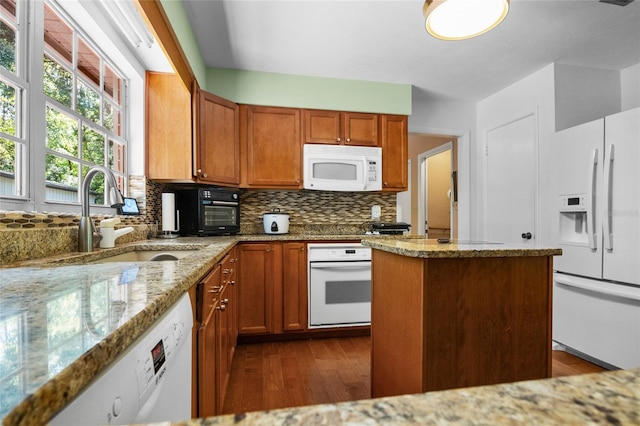 2809 SW 81st St, Gainesville, FL 32608 - kitchen with white appliances, dark wood-style floors, backsplash, and light stone counters