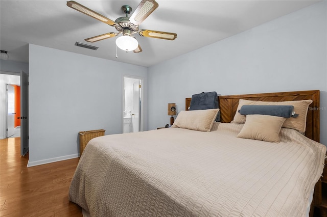 2809 SW 81st St, Gainesville, FL 32608 - bedroom featuring wood finished floors, ceiling fan, and ensuite bath