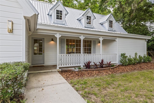 10943 NW 34th Pl, Gainesville, FL 32606 - view of front of house featuring covered porch and a metal roof