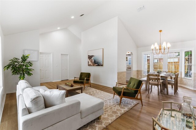 10943 NW 34th Pl, Gainesville, FL 32606 - living area featuring a chandelier, high vaulted ceiling, and wood finished floors