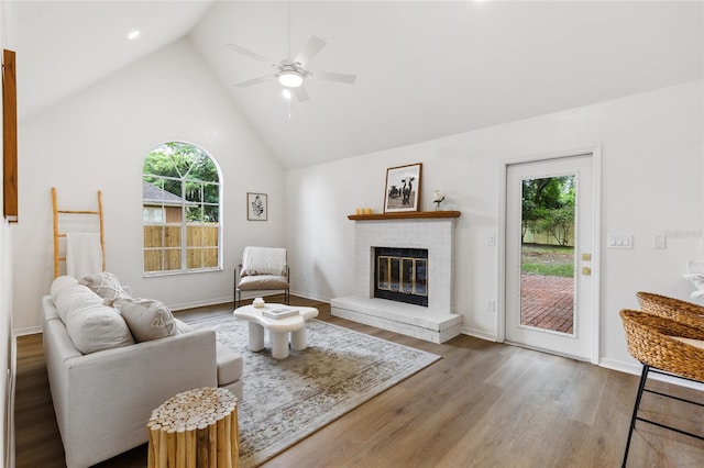 10943 NW 34th Pl, Gainesville, FL 32606 - living area with healthy amount of natural light, ceiling fan, wood finished floors, a fireplace, and high vaulted ceiling