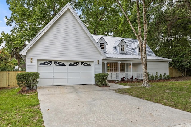 10943 NW 34th Pl, Gainesville, FL 32606 - view of front of home with a porch, driveway, an attached garage, and a metal roof